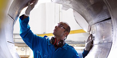 Ingegnere aeronautico che ispeziona l'inversore di propulsione di un 737

