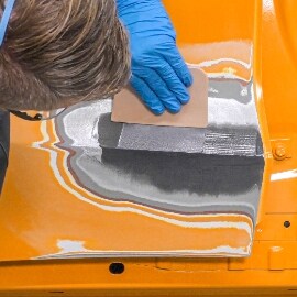 applicazione di un secondo strato di stucco epossidico per metalli per stuccatura di ammaccature